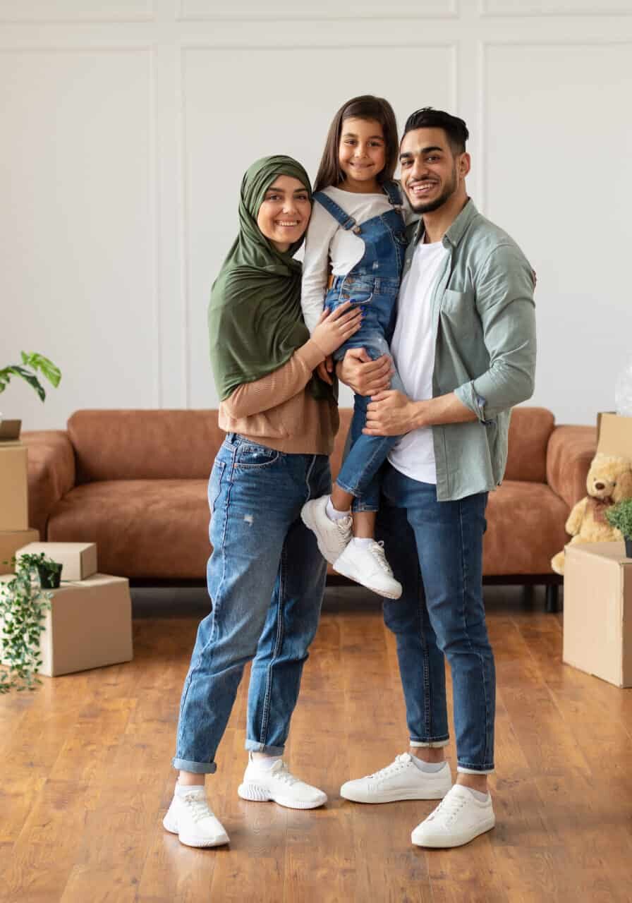 Happy Muslim Family Looking At Camera Posing On Moving Day